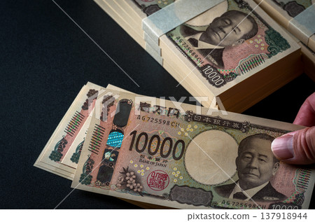 A stack of bills. A dark image. 137918944