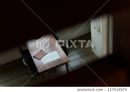 A dining table set in a dark room 137918974