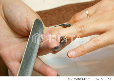 Nail salon: A woman's hands being groomed. 137920035