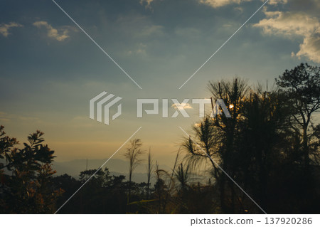 sunset with moving of cloud and clear sky and layer of mountain sunset with moving of cloud and clear sky and layer of mountain 137920286