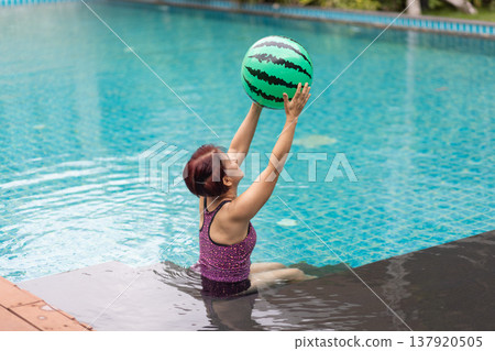 Senior asian woman have relax and recreation on swimming pool. 137920505