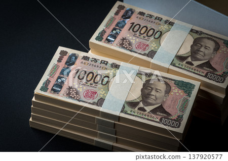 A stack of bills. A dark image. 137920577