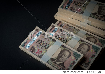 A stack of bills. A dark image. 137920588