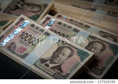 A stack of bills. A dark image. 137920590