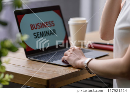 Attending business seminars on a laptop 137921214