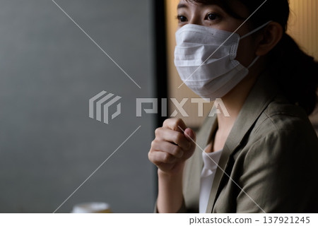 A woman who masks and coughs A woman who masks and coughs 137921245