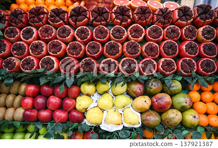 Rows of ripe fruits are laid out on the counter of the street market 137921387