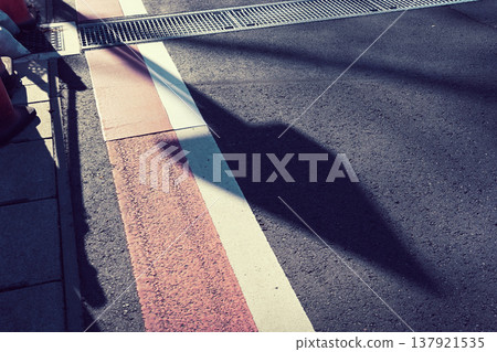 Shadow of a road sign cast on the road surface Shadow of a road sign cast on the road surface 137921535