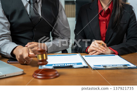 Business lawyer meeting working with paperwork on desk in office workplace for consultant lawyer in office. Business lawyer meeting working with paperwork on desk in office workplace for consultant lawyer in office. 137921735
