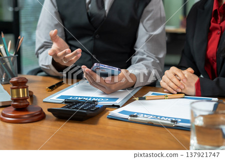 Business lawyer meeting working with paperwork on desk in office workplace for consultant lawyer in office. Business lawyer meeting working with paperwork on desk in office workplace for consultant lawyer in office. 137921747