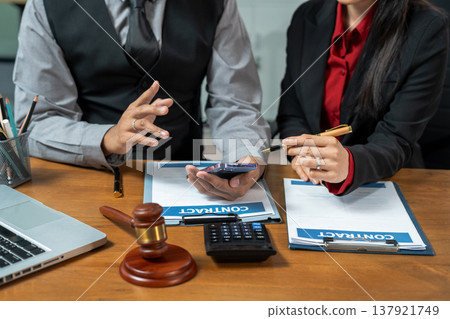 Business lawyer meeting working with paperwork on desk in office workplace for consultant lawyer in office. 137921749