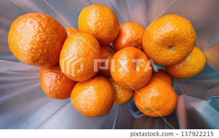 Fresh Ripe Tangerines and Mandarins in a Translucent Plastic Bag Fresh Ripe Tangerines and Mandarins in a Translucent Plastic Bag 137922215