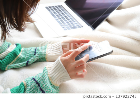 A woman using a smartphone; a freelancer. 137922745