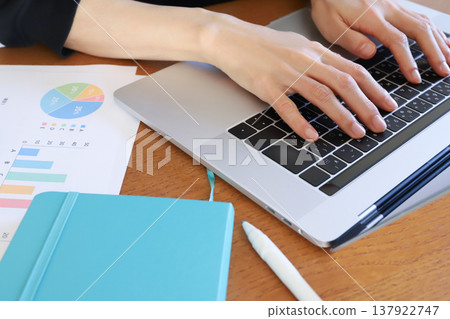 Hands working with a computer 137922747