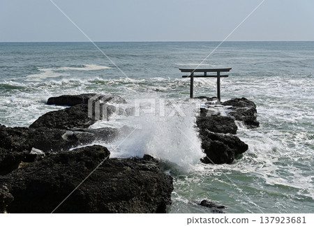 Ibaraki Prefecture, Oarai Isomae Shrine, Kamiiso Torii Gate: A close-up view of the torii gate amidst the crashing waves against the rocky shore. 137923681