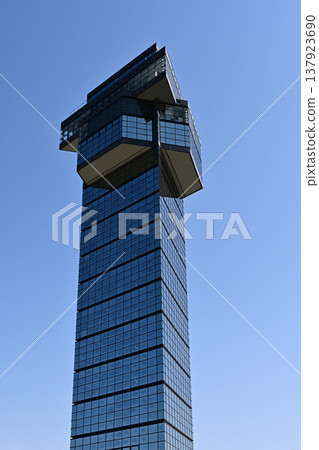 Oarai Marine Tower, Oarai Town, Ibaraki Prefecture: A glass-enclosed observation tower soaring into the blue sky; a photograph of its modern and aesthetically pleasing exterior. Oarai Marine Tower, Oarai Town, Ibaraki Prefecture: A glass-enclosed observation tower soaring into the blue sky; a photograph of its modern and aesthetically pleasing exterior. 137923690