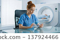 Female doctor consulting with a holographic medical assistant for advanced heart scan analysis 137924466