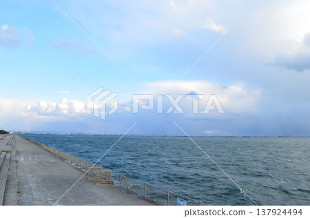 A tranquil scene capturing the coastline and seawall of Kobe. A tranquil scene capturing the coastline and seawall of Kobe. 137924494
