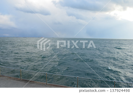 一幅寧靜的畫面，捕捉了神戶的海岸線和海堤風景。 137924498