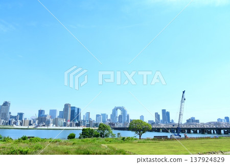 Osaka cityscape seen from the Yodogawa riverbed Osaka cityscape seen from the Yodogawa riverbed 137924829
