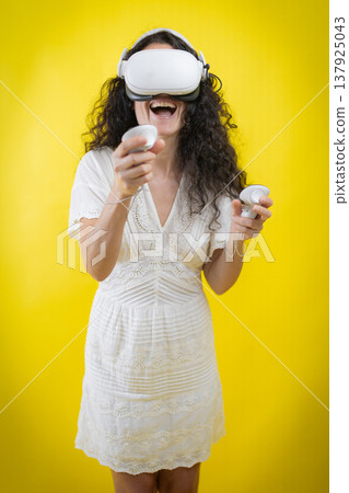 Woman experiencing virtual reality enjoying immersive media concept Woman experiencing virtual reality enjoying immersive media concept 137925043