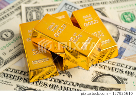 Gold bar on US dollar and Euro banknote, economy finance exchange trade investment. Gold bar on US dollar and Euro banknote, economy finance exchange trade investment. 137925610