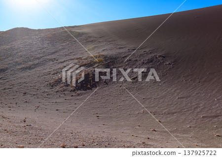 Vast silent desert of Valle de la Luna with arid sand dune under blue sky Vast silent desert of Valle de la Luna with arid sand dune under blue sky 137925722