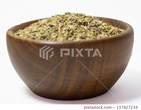 A rustic bowl with anise seeds with white background. Healthy seeds concept A rustic bowl with anise seeds with white background. Healthy seeds concept 137927239
