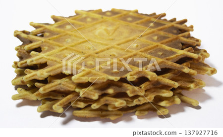 Pile of pizzelles on white background.Side view 137927716