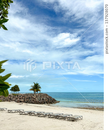 Sunbeds at midday on a sunny Bahamian beach. Summer concept. Copy space Sunbeds at midday on a sunny Bahamian beach. Summer concept. Copy space 137928070