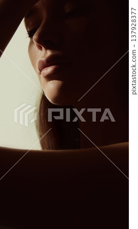 Female lips and chin in soft shadow warm light beauty minimal style. 137928377