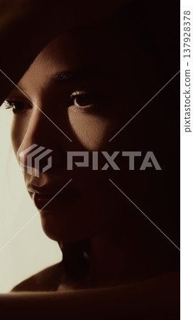 Female face close up with dramatic shadows cinematic beauty lighting. 137928378