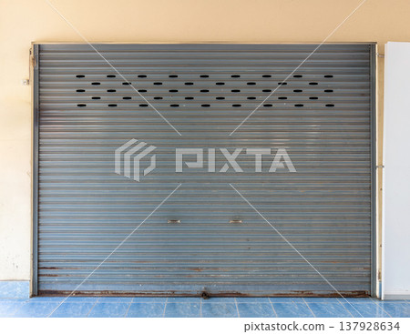 Gray Metal Rolling Shutter Door of School Building. Gray Metal Rolling Shutter Door of School Building. 137928634