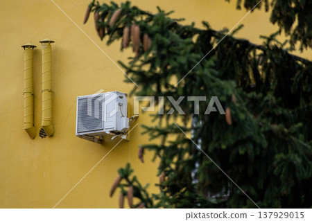 air conditioning on facade of building, air cooling in hot weather.  137929015