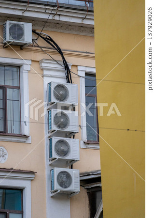 air conditioning on facade of building, air cooling in hot weather.  137929026