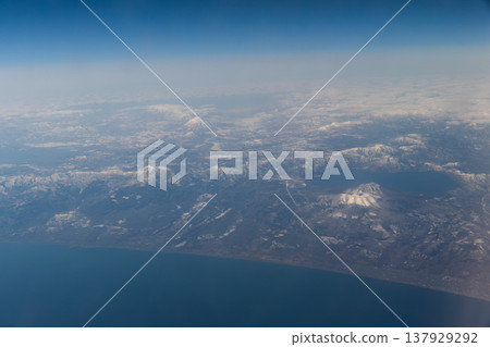 Lake Shikotsu and Mount Tarumae as seen from an airplane, with Mount Yotei (Ezo Fuji) rising in the distance. Lake Shikotsu and Mount Tarumae as seen from an airplane, with Mount Yotei (Ezo Fuji) rising in the distance. 137929292