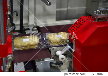 Industrial food packaging line with eco-friendly paper containers in a modern manufacturing factory Industrial food packaging line with eco-friendly paper containers in a modern manufacturing factory 137930079