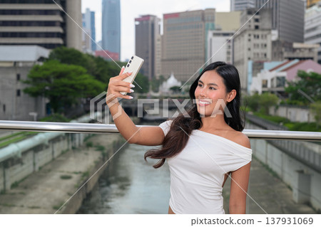 Thai Woman Taking Selfie at Kuala Lumpur River of Life Thai Woman Taking Selfie at Kuala Lumpur River of Life 137931069
