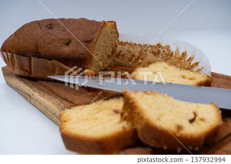 Slicing pound cake on wooden board for serving Slicing pound cake on wooden board for serving 137932994