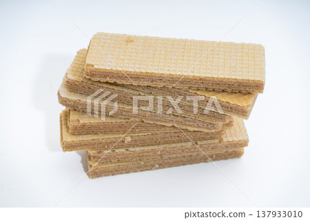 Stacked crunchy vanilla cream filled wafers on white background Stacked crunchy vanilla cream filled wafers on white background 137933010
