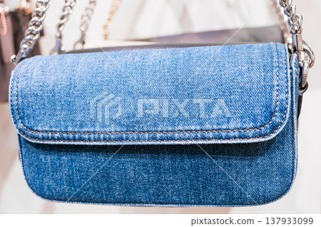 Denim handbag displayed at a store showcases modern fashion with stylish design elements 137933099