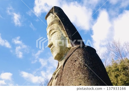 Blue spotlights vividly illuminate the silent stone Buddha. Blue spotlights vividly illuminate the silent stone Buddha. 137933166