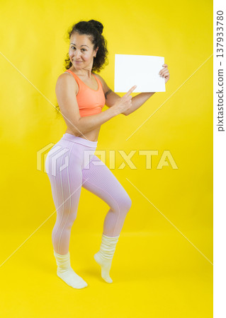 Woman holding empty white sign presenting healthy lifestyle Woman holding empty white sign presenting healthy lifestyle 137933780