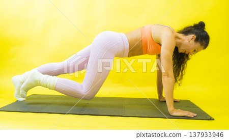 Woman exercising plank pose demonstrating strength and fitness Woman exercising plank pose demonstrating strength and fitness 137933946