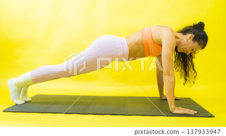 Woman doing plank exercise for core strength Woman doing plank exercise for core strength 137933947