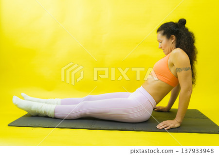 Woman exercising core muscles on fitness mat Woman exercising core muscles on fitness mat 137933948