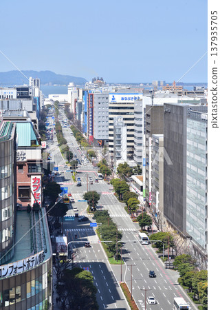 Ohakudori Street, in front of JR Hakata Station. You can see Hakata Bay and Shikanoshima Island. Photographed from the rooftop of the JR Hakata Station building. 137935705