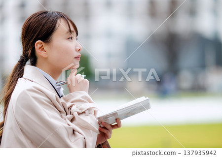 A businesswoman carrying a carry-on bag A businesswoman carrying a carry-on bag 137935942