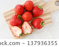 A cross-section of an Amarin strawberry and fresh strawberries 137936355