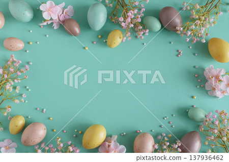 Pastel Easter Eggs and Flowers on Teal Background. Festive Spring Flatlay Pastel Easter Eggs and Flowers on Teal Background. Festive Spring Flatlay 137936462
